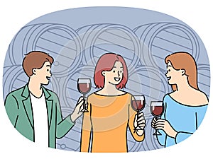 Smiling people tasting wine in cellar