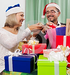 Smiling persons packed gifts