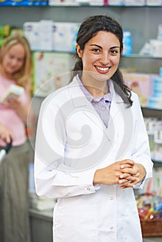 Smiling pharmacy chemist portrait in drugstore