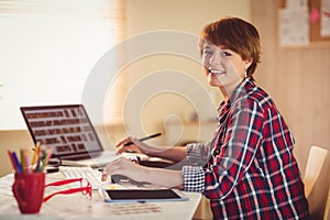 Smiling photographer looking at camera