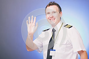 Smiling pilot waving his hand