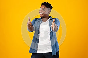 Smiling Plus-Size African Woman Pointing Fingers At Camera, Yellow Background