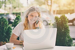 Smiling plus size model girl with laptop and smartphone