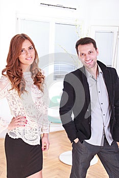 Smiling portrait of a female and male business executives at off