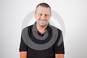 Smiling portrait middle aged man isolated on black shirt and white grey background