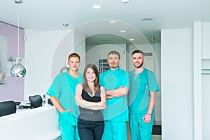 Smiling portrait team in uniform providing healthcare treatment in modern medical centre. Clinic, profession, people, health care