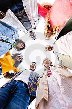 Smiling portrait of young friends in circle looking at camera