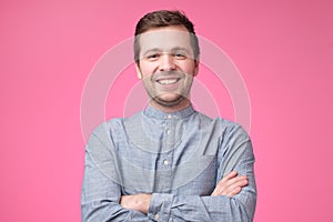 Smiling positive caucasian man in blue shirt