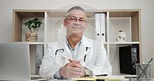 Smiling Positive Doctor At Work Looking at Camera