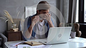 Smiling positive professional businessman working on laptop computer at home