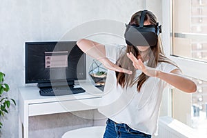 Smiling positive woman wearing virtual reality goggles headset, vr box. Connection, technology, new generation, progress concept.