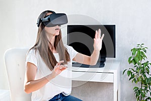 Smiling positive woman wearing virtual reality goggles headset, vr box. Connection, technology, new generation, progress concept.