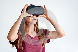 Smiling positive woman wearing virtual reality goggles headset, vr box. Connection, technology, new generation, progress concept.