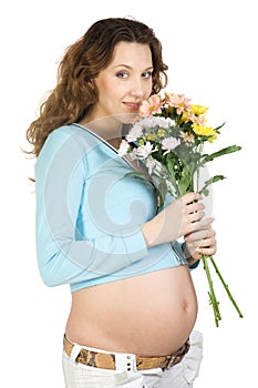 Smiling pregnant brunette with flower
