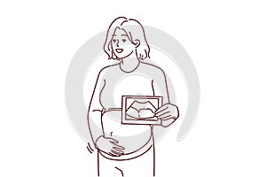 Smiling pregnant woman with baby scan