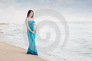 Smiling Pregnant Woman on the Beach