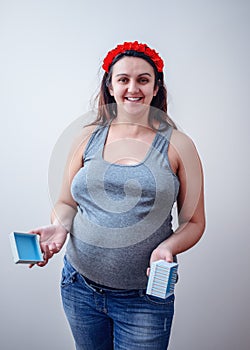 Smiling pregnant woman with box