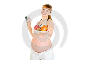 Smiling pregnant woman choosing healthy lifestyle