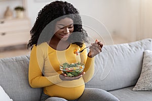 Smiling pregnant woman enjoying healthy food, copy space
