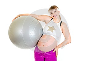 Smiling pregnant woman holding fitness ball