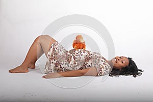 Smiling pregnant woman with orangutan toy