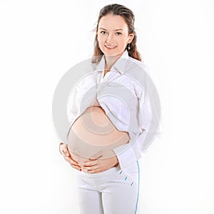 Smiling pregnant woman resting her hands on her tummy