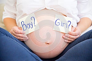 Smiling pregnant woman waiting for a boy or girl