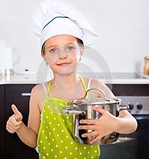 Smiling preschooler posing with pan