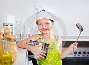 Smiling preschooler posing with pan
