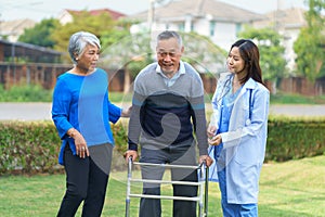 Smiling pretty caregiver and old man with walking at hospital. concept healthcare