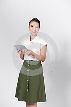 Smiling pretty girl holding a digital tablet computer