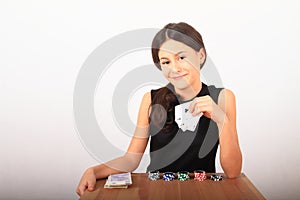 Smiling pretty girl - kid playing poker with money