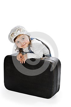 Smiling pretty little girl with old suitcase