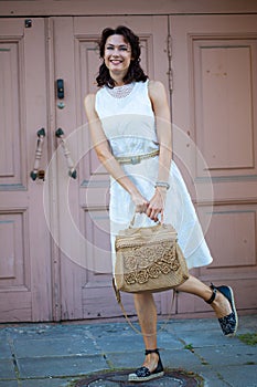 Smiling pretty middle-aged woman in white dress