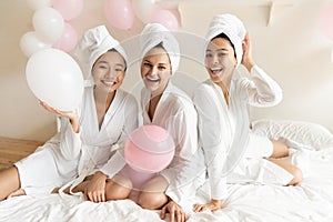 Smiling pretty multiracial girls feeling relaxed after spa procedures.