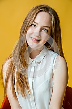 Smiling pretty woman sitting on the chair