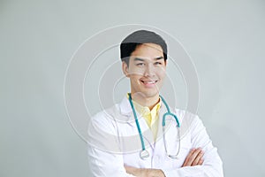 Smiling Professional Asian man Psychiatrist MD and smart doctor in White gown uniform portrait