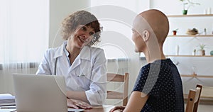 Smiling professional oncology specialist consulting patient with cancer.