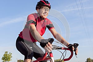 Smiling Professional Road Cyclist During Ride on Bike Outdoors.