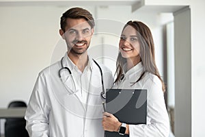 Smiling professionals male doctor and female nurse looking at camera