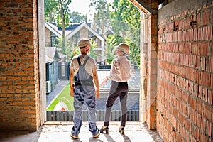 Smiling project manager inspecting together with contractor building