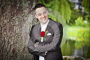 Smiling proud groom - young male in suit