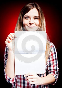 Smiling and proud young girl holding exercise book