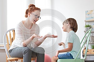 Psychotherapist talking with autistic boy