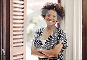 Smiling real estate agent looking motivated, ambitious and confident with arms crossed in new listing, rental or