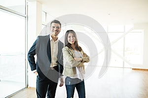 Smiling Real Estate Agents Standing In New Apartment photo