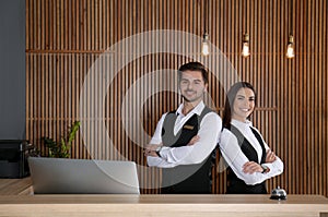 Smiling receptionists at desk in lobby