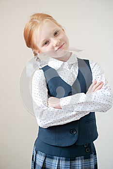 Smiling red-haired schoolgirl indoors
