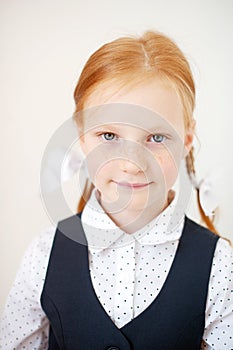 Smiling red-haired schoolgirl indoors