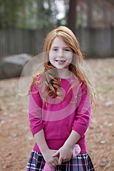 Smiling redhead girl with missing teeth